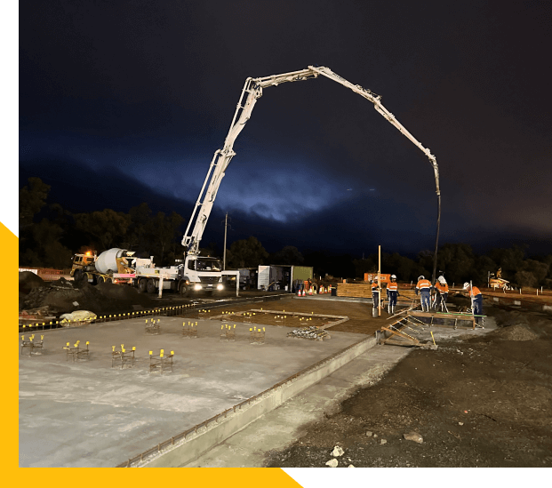 Nighttime construction with concrete pump, highlighting Slamm Services' civil and construction expertise. Nighttime construction with concrete pump, highlighting Slamm Services' civil and construction expertise.